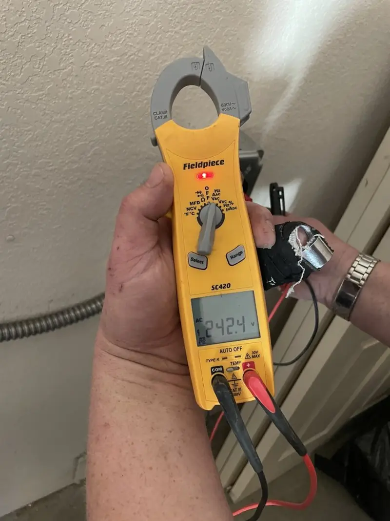 Voltage testing with clamp meter during Electrical Installation Services in Garden City